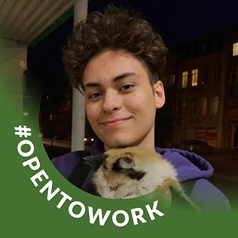 Me with a sign saying 'Open to work'